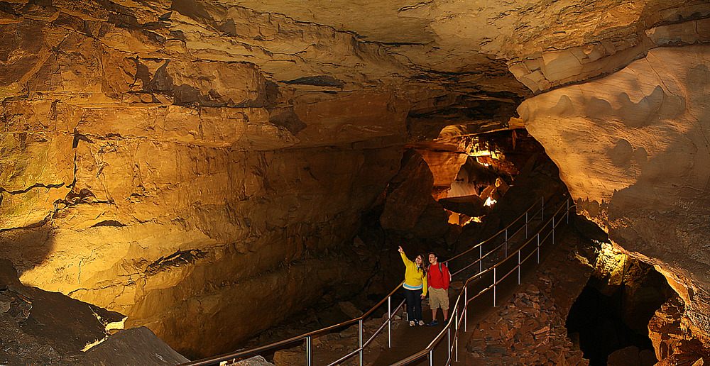 Visitors on a walkway through a passage in Mammoth Cave.