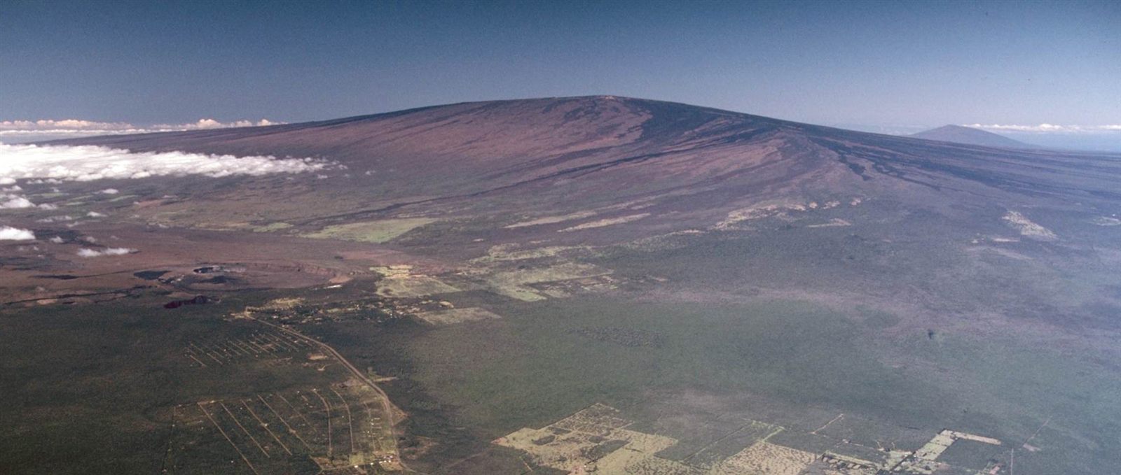 Aerial view of Mauna Loa volcano rising above Kilauea's summit caldera, Hawaii.